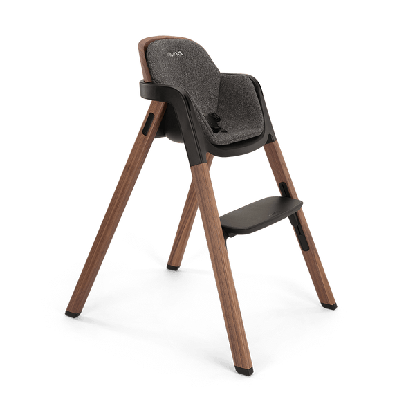 Modern wooden nuna bryn highchair with gray textured fabric seat black accents and nuna logo in sanderson finish