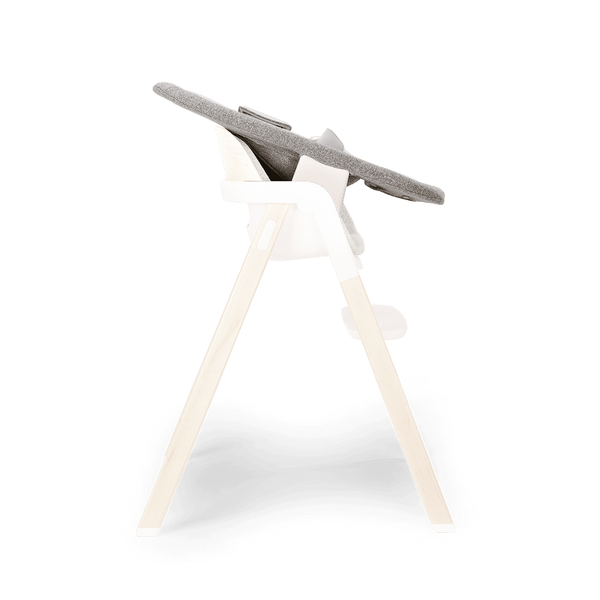 Modern high chair with gray fabric seat white plastic frame and light wood legs in Nuna BRYN newborn rocker heritage style