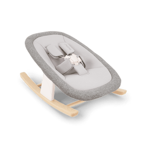 Gray textured fabric baby rocker with light wood base and white plastic support nuna bryn newborn rocker heritage