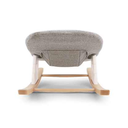 Nuna bryn newborn rocker with gray textured fabric seat and light wood frame with white plastic accents