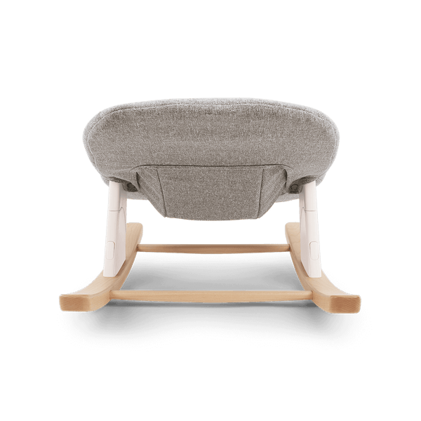 Nuna bryn newborn rocker with gray textured fabric seat and light wood frame with white plastic accents