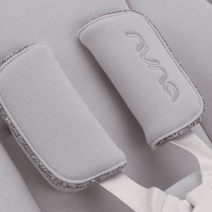 Gray fabric headrest pads with silver glitter trim and embroidered nuna logo for nuna bryn highchair and newborn rocker bundle heritage