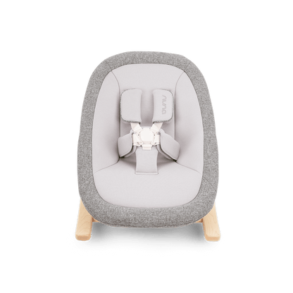 Gray and white fabric nuna bRYN newborn rocker with wooden legs designed for infant comfort and soothing motion