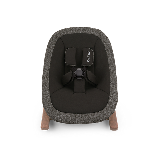 A modern nuna bryn newborn rocker baby bouncer with textured charcoal gray fabric and light wood legs