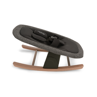 Nuna BRYN newborn rocker with textured charcoal gray fabric, black padded interior, and adjustable safety straps