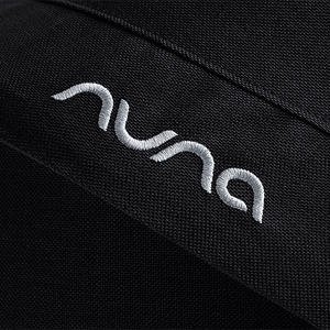Black textured fabric with white embroidered nuna logo on caviar nuna mixx next stroller seat material