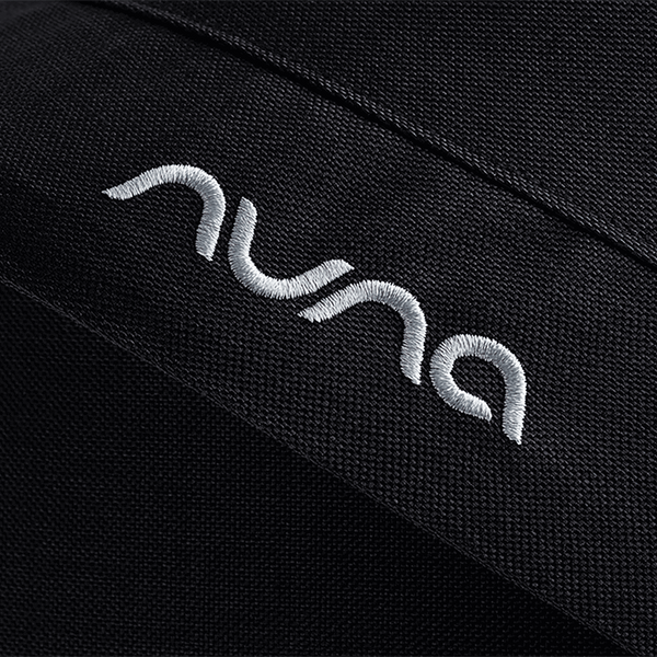 Black textured fabric with white embroidered nuna logo on caviar nuna mixx next stroller seat material