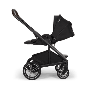 Nuna mixx next stroller in caviar black with sleek frame brown leather handle and silver accented wheels shown from back side