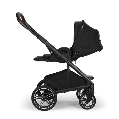 Nuna mixx next stroller in caviar black with sleek frame brown leather handle and silver accented wheels shown from back side