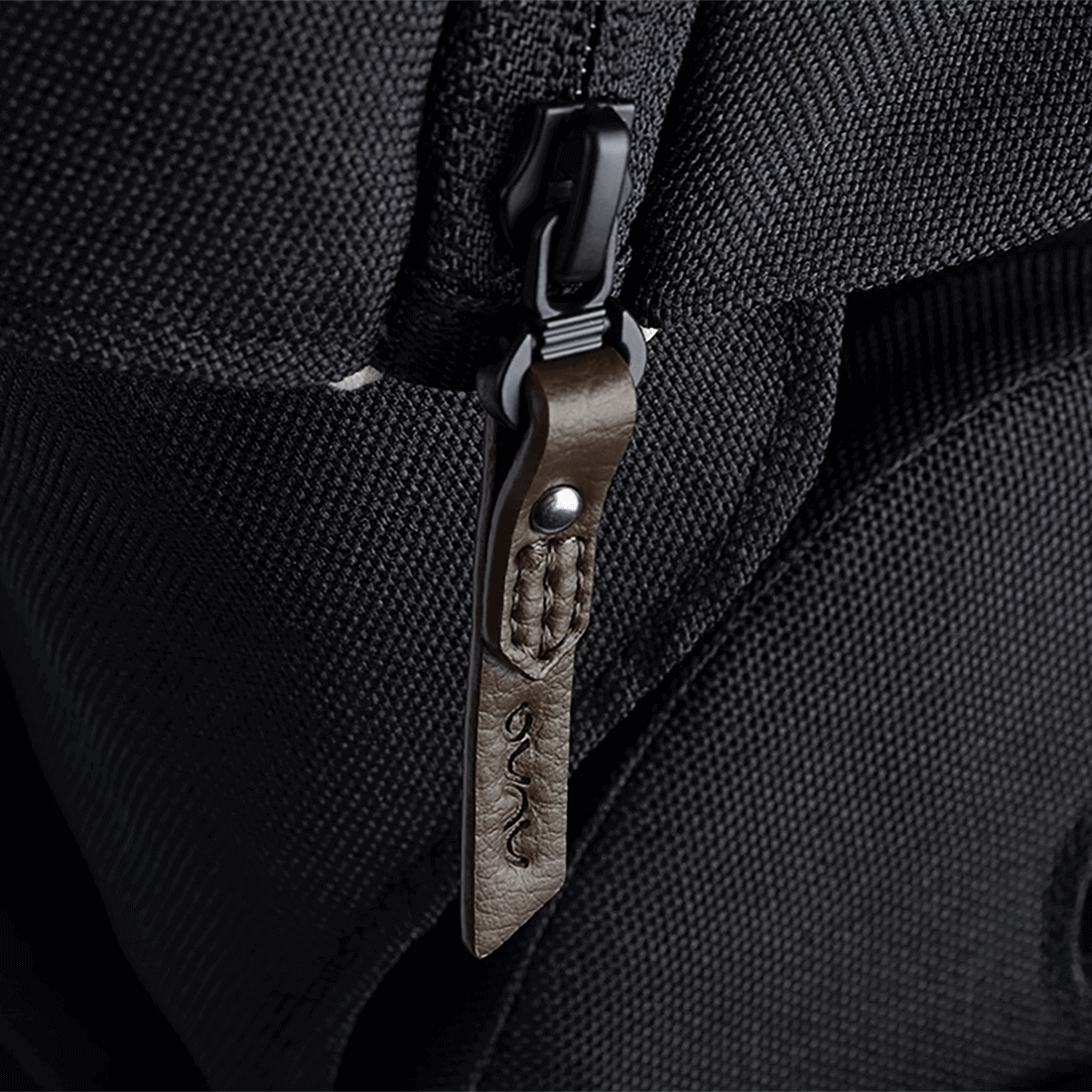 Nuna MIXX NEXT stroller black textured fabric backpack with brown leather embossed zipper pull and silver metal rivet