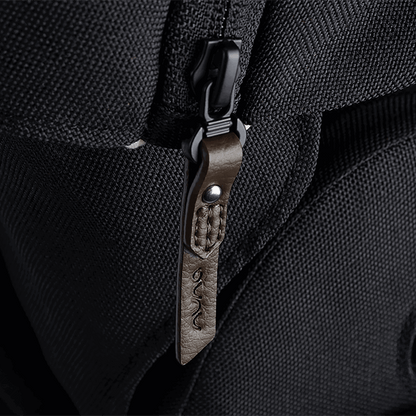 Nuna MIXX NEXT stroller black textured fabric backpack with brown leather embossed zipper pull and silver metal rivet