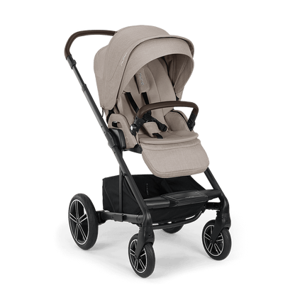 Nuna MIXX NEXT stroller in beige and black with padded fabric seating and alloy wheels in a sleek modern design