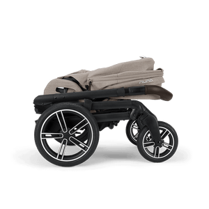 Beige fabric nuna mixx next stroller with black frame and silver-accented wheels featuring a sleek modern design
