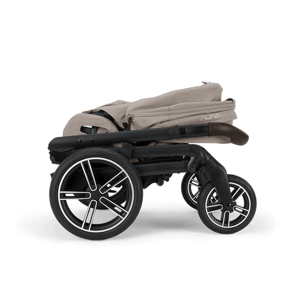 Beige fabric nuna mixx next stroller with black frame and silver-accented wheels featuring a sleek modern design