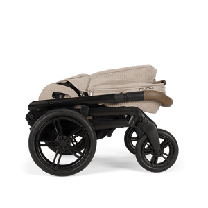 Beige and black nuna mixx next stroller with soft quilted fabric canopy and sleek modern frame in cosmopolitan style