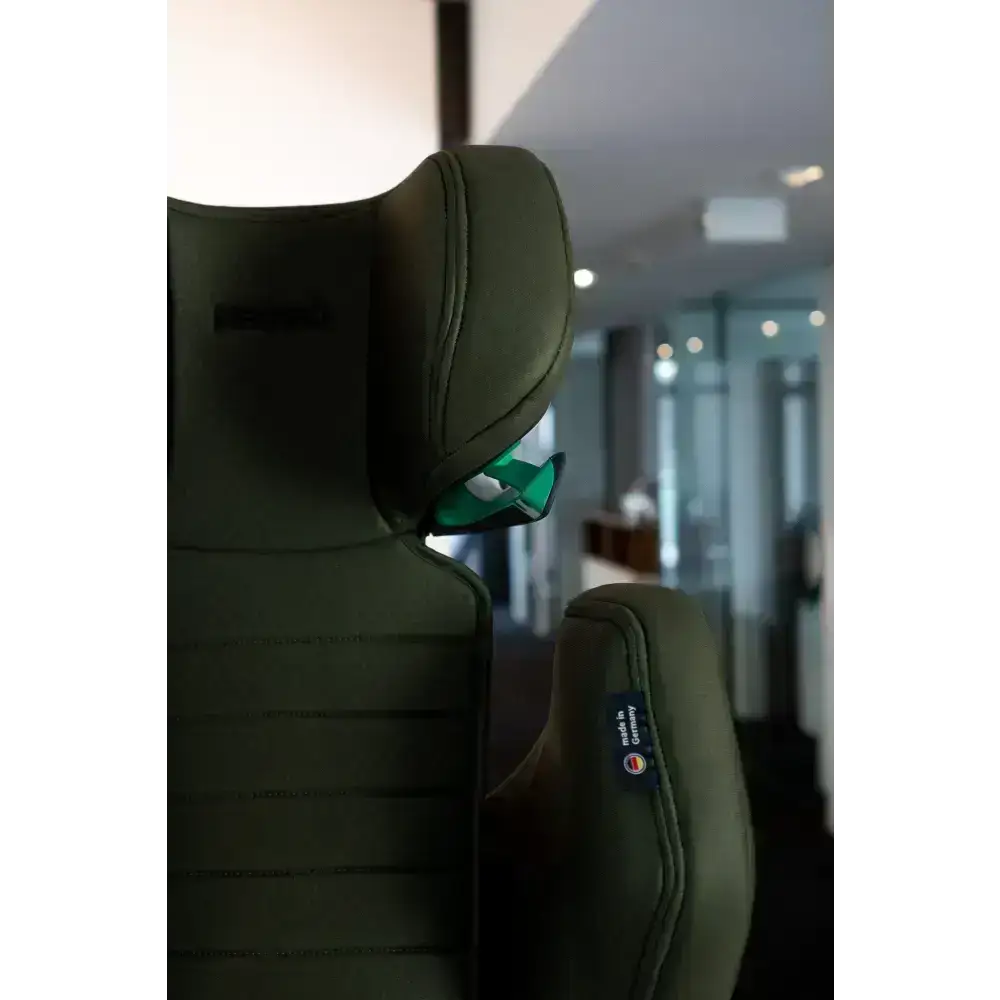 Close-up of the Epic Green headrest, green shoulder belt guide and stitched side wing.
