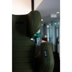 Close-up of the Epic Green headrest, green shoulder belt guide and stitched side wing.