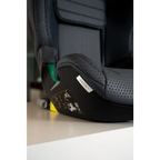 Close-up of the Gallant Grey seat cushion and black base, showing the AXION 1 label and green lap belt guide.