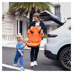 Adult holding the Vibrant Orange AXION 1 beside a child and a white vehicle with its boot open.
