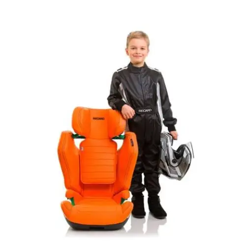 Child in a black racing suit holding a helmet beside the Vibrant Orange Recaro AXION 1.