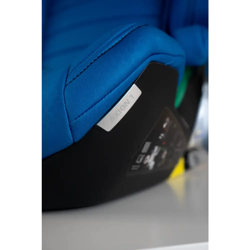 Close-up of Calm Blue seat stitching, the AXION 1 label and black base.