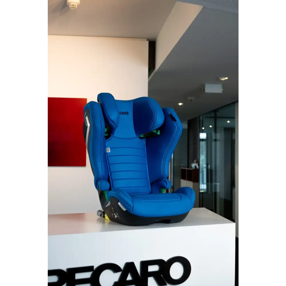 Recaro AXION 1 in Calm Blue on a white Recaro display stand, showing the padded seat and headrest.