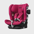 Recaro VELIX 1 in Wow Pink, angled front view with padded harness, black base and outer side attachment.