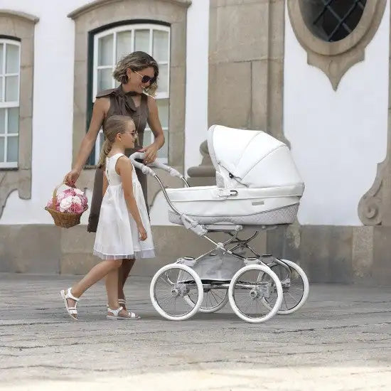 White pram with silver accents and a matching canopy.